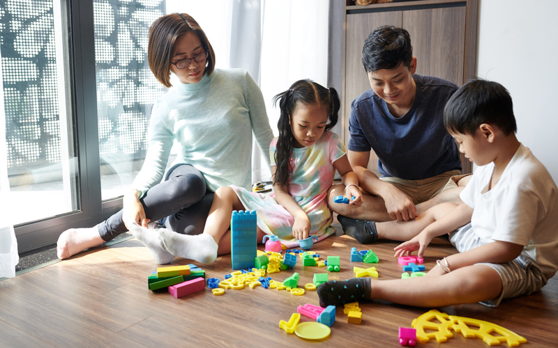 Family playing with toys on floor -Tips to build wealth