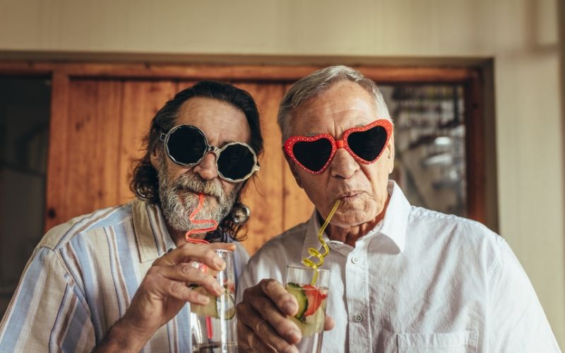 Two older men drinking cocktails - best places to retire