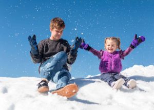 children playing in the snow - school holiday fun