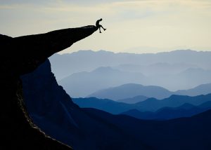 man sitting on cliff